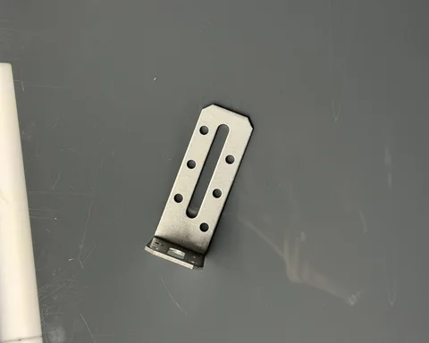 Metal component with holes and an elongated cutout